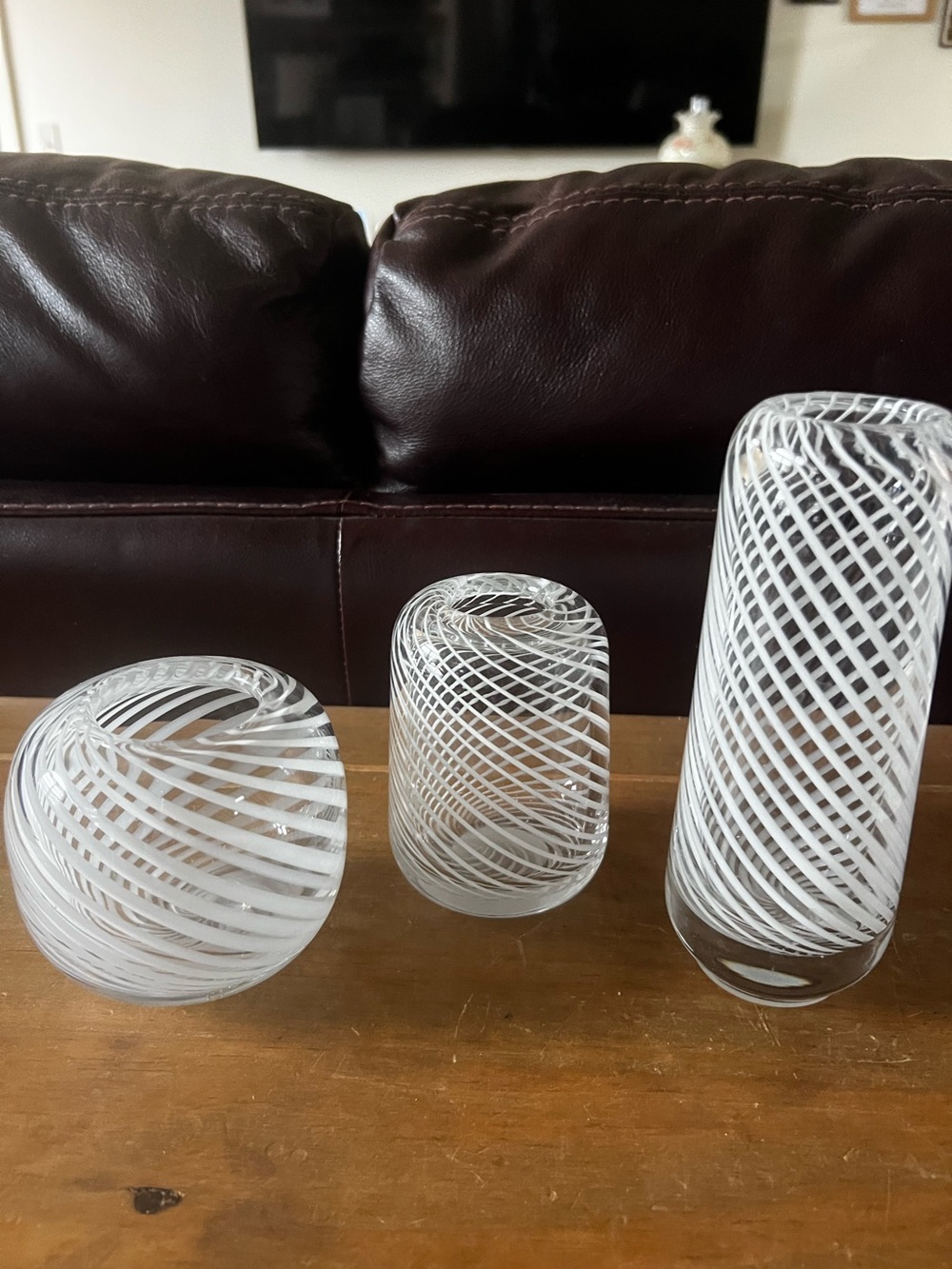 Set of three hand blown vases. Beautiful with white swirls.